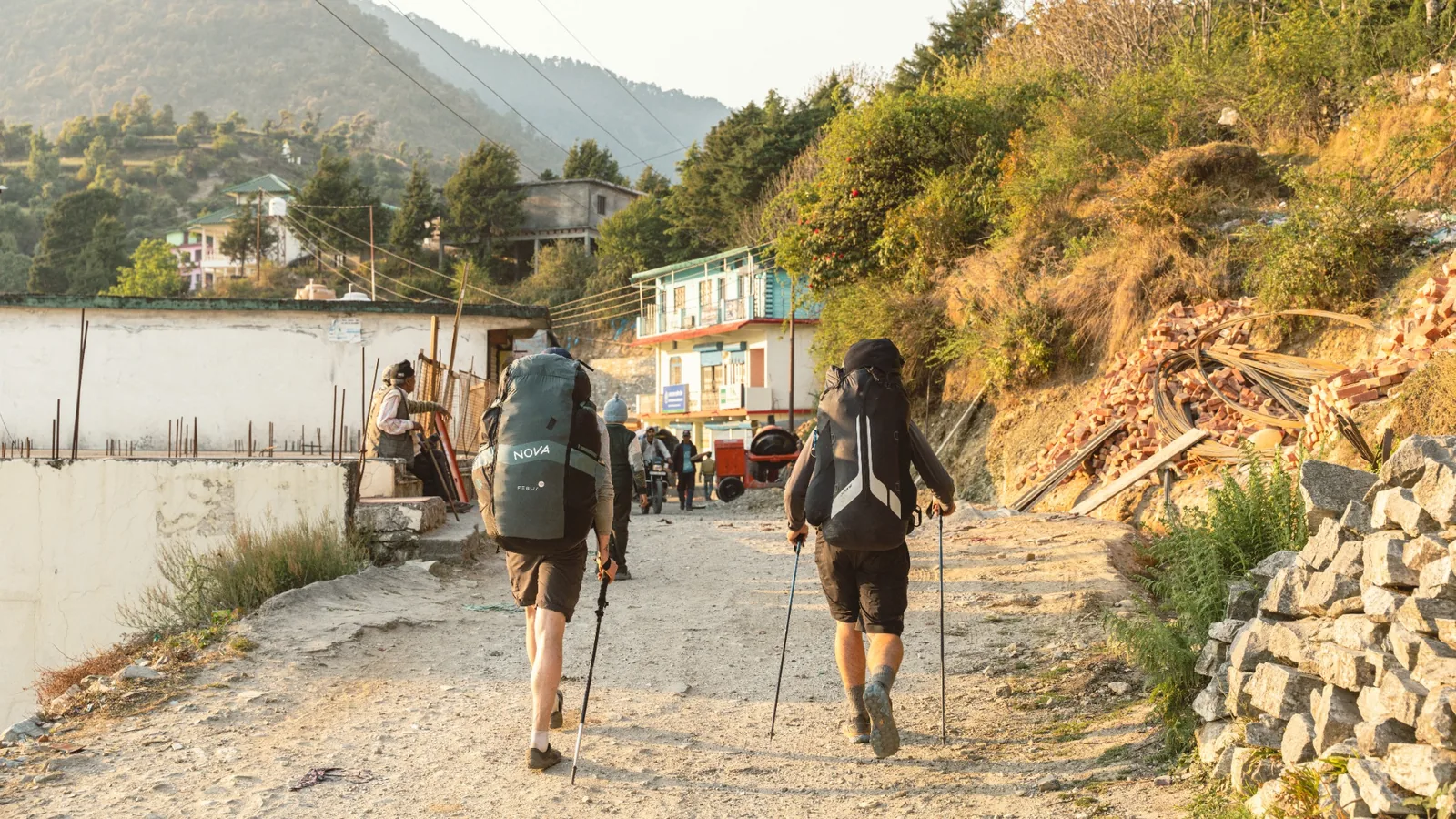 Expedition team walking through a mountain village